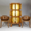 Carl Hörvik's luxurious oak cabinet is inlayed with rosewood, birch, Hungarian ash and boasts a dazzling gilded, gold-leaf interior. It is accompanied by two matching armchairs and the set was designed by the Swedish architect for the reception hall of th